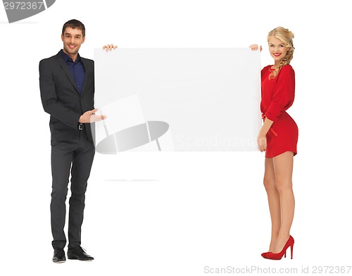 Image of couple holding big blank white board