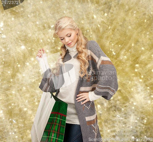 Image of smiling young woman with shopping bags
