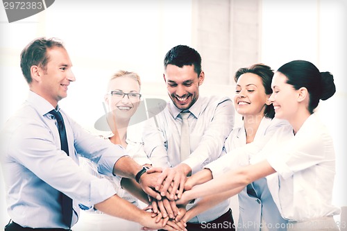 Image of business team celebrating victory in office