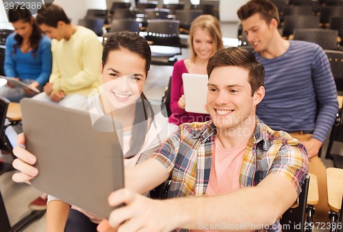 Image of group of smiling students with tablet pc