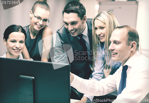 Image of business team with monitor having discussion