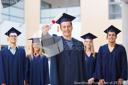 Image of group of smiling students in mortarboards