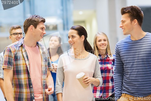 Image of group of smiling students with paper coffee cups