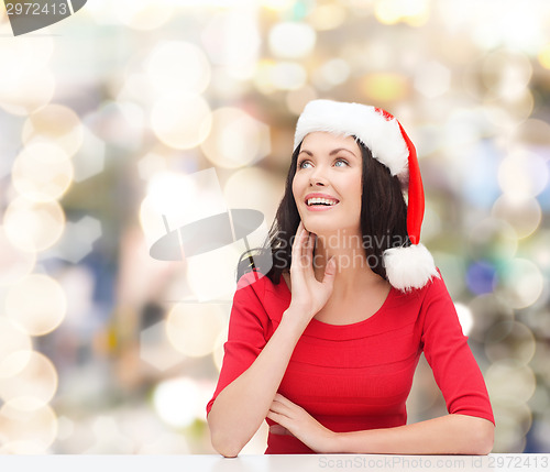 Image of smiling woman in santa helper hat