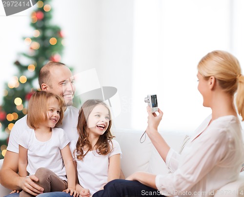 Image of happy family with camera at home