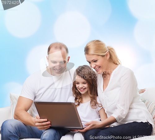 Image of smiling family with laptop