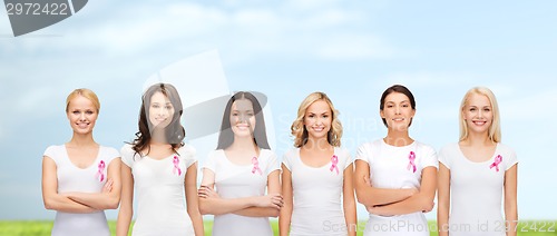 Image of smiling women with pink cancer awareness ribbons