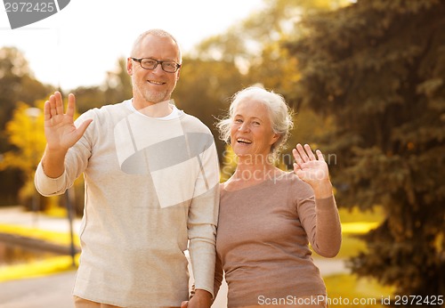Image of senior couple hugging in city park