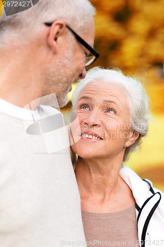 Image of senior couple hugging in city park