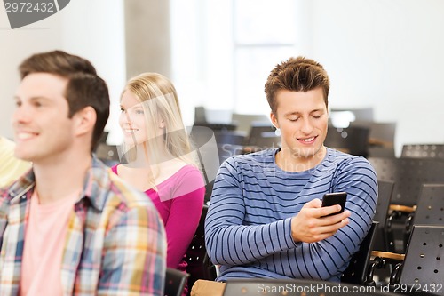Image of group of smiling students in lecture hall