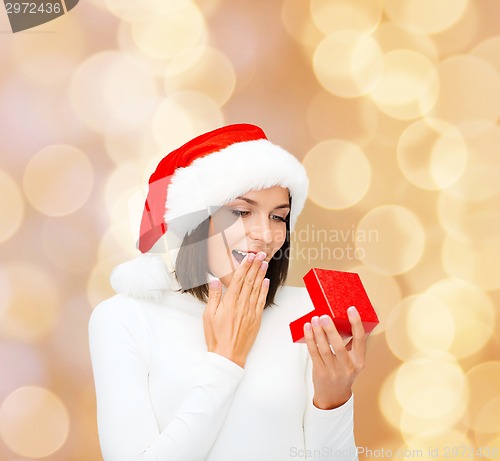 Image of smiling woman in santa helper hat with gift box