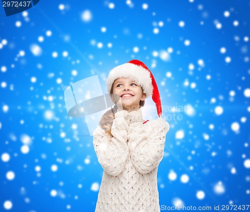 Image of dreaming girl in santa helper hat