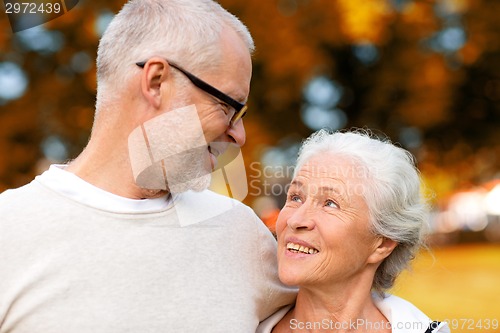 Image of senior couple hugging in city park