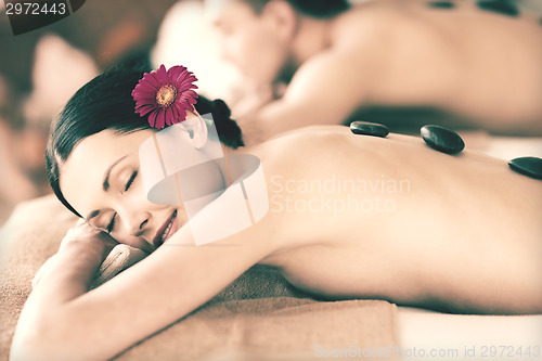 Image of couple in spa with hot stones