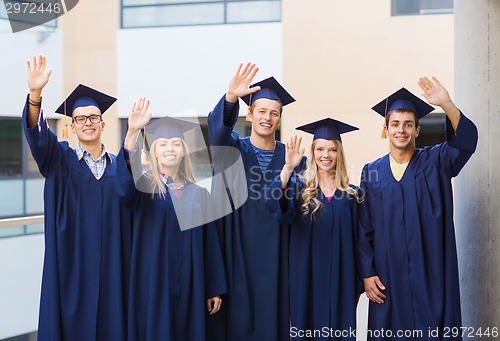 Image of group of smiling students in mortarboards