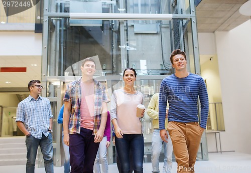 Image of group of smiling students with paper coffee cups