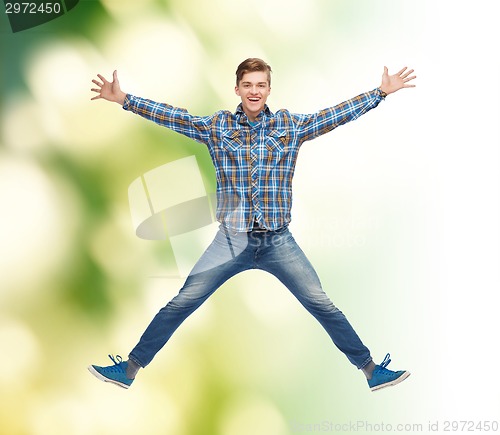 Image of smiling young man jumping in air