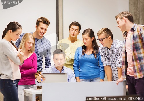 Image of group of students and teacher with laptop