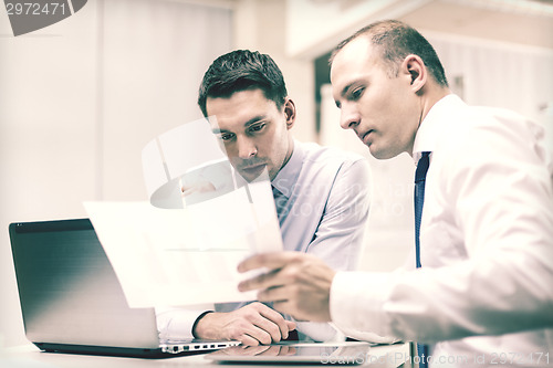 Image of two businessmen having discussion in office