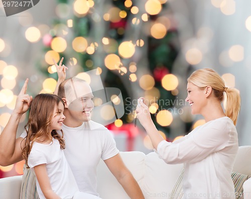 Image of happy family with camera at home