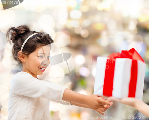 Image of smiling little girl with gift box