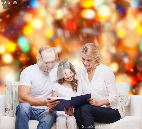 Image of happy family with book at home