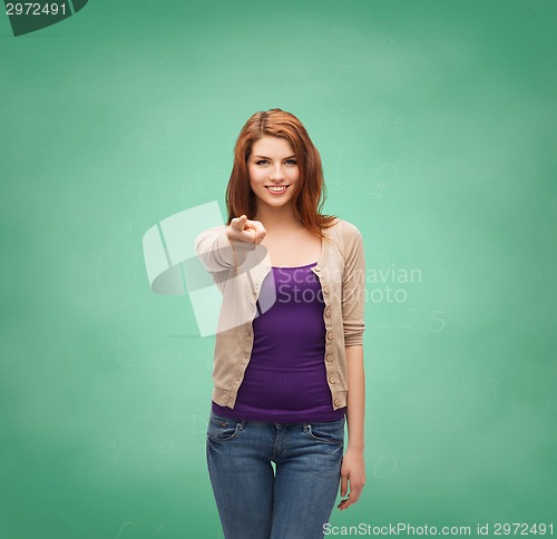 Image of smiling teenage girl pointing finger at you