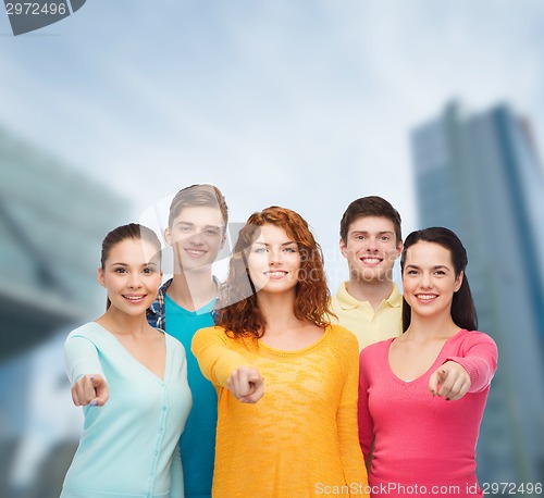 Image of group of smiling teenagers over city background