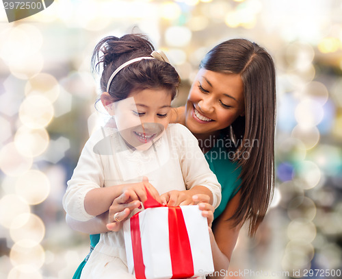 Image of happy mother and little girl with gift box