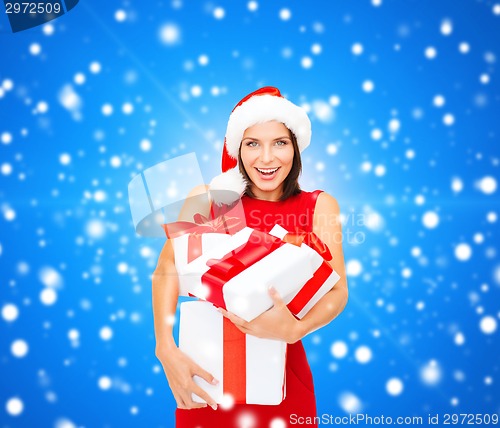 Image of smiling woman in red dress with gift boxes