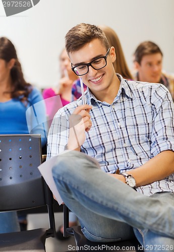 Image of group of smiling students with notebook