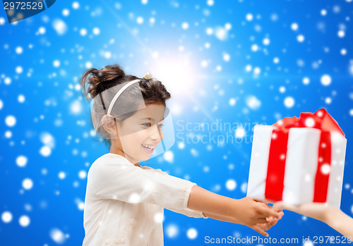 Image of smiling little girl with gift box