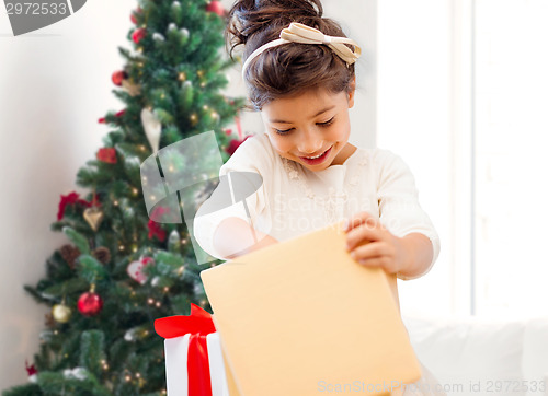 Image of smiling little girl with gift box