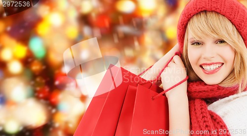 Image of smiling young woman with shopping bags