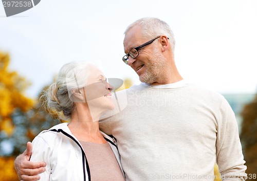 Image of senior couple hugging in city park