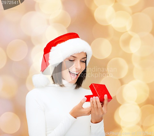 Image of smiling woman in santa helper hat with gift box