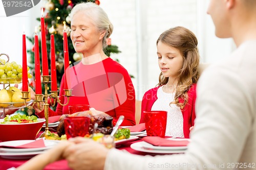 Image of smiling family having holiday dinner at home