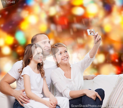 Image of happy family with camera at home