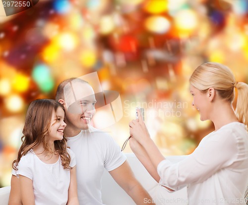 Image of happy family with camera at home