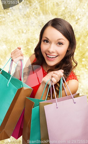 Image of smiling woman with colorful shopping bags