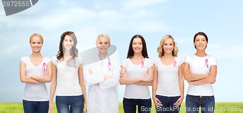 Image of smiling women with pink cancer awareness ribbons