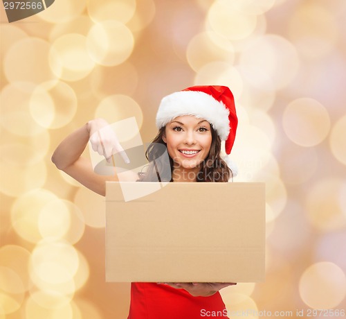Image of smiling woman in santa helper hat with parcel box
