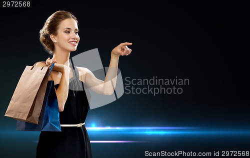 Image of smiling woman in dress with shopping bags
