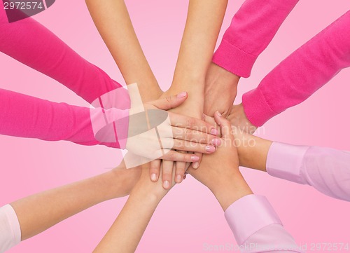 Image of close up of women with hands on top