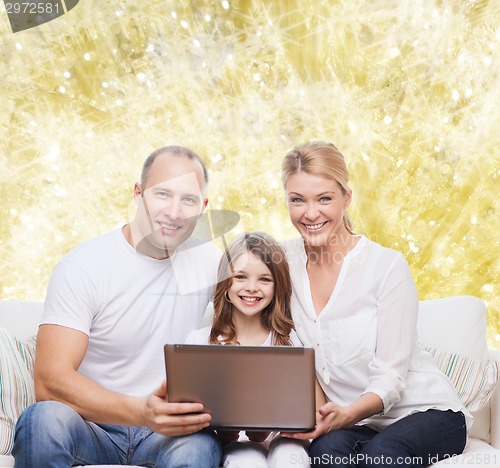 Image of smiling family with laptop