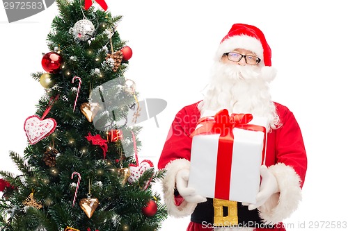 Image of man in costume of santa claus with gift box