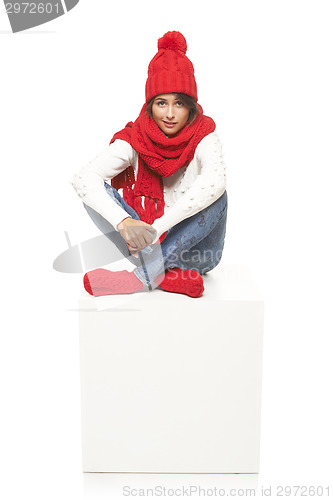 Image of Winter woman sitting on blank billboard placard sign