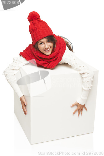 Image of Winter woman hugging big white box