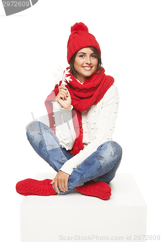 Image of Winter woman sitting on blank billboard placard sign