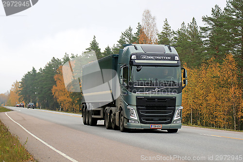 Image of Green Volvo FH Semi Truck on the Road in Autumn